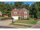 Charming brick home with black shutters, a manicured lawn, and a welcoming front entrance at 440 Homeplace Dr, Stockbridge, GA 30281