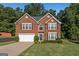 Beautiful two-story brick home with a manicured lawn and attached two-car garage at 440 Homeplace Dr, Stockbridge, GA 30281