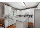 Bright kitchen with white cabinets, stainless steel appliances, and a central island with bar seating at 440 Homeplace Dr, Stockbridge, GA 30281