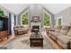 Inviting living room with vaulted ceilings, large windows, hardwood floors, and a cozy fireplace at 440 Homeplace Dr, Stockbridge, GA 30281
