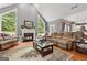 Inviting living room with vaulted ceilings, large windows, hardwood floors, and a cozy fireplace at 440 Homeplace Dr, Stockbridge, GA 30281