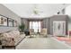 Cozy living room with floral sofa, two chairs, piano, and light gray paint at 440 Homeplace Dr, Stockbridge, GA 30281