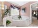 The ensuite bathroom includes a corner soaking tub with jets and decorative plants at 440 Homeplace Dr, Stockbridge, GA 30281