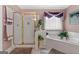 The ensuite bathroom features a corner jetted soaking tub and tiled walk-in shower at 440 Homeplace Dr, Stockbridge, GA 30281