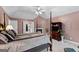Primary bedroom featuring a fireplace, neutral colored carpet, and access to a walk-in closet at 440 Homeplace Dr, Stockbridge, GA 30281