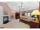 Spacious primary bedroom with a fireplace, sitting area and four-poster bed at 440 Homeplace Dr, Stockbridge, GA 30281