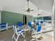 A covered patio features tables and chairs, offering a relaxing outdoor space near the community's tennis courts at 440 Homeplace Dr, Stockbridge, GA 30281