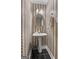 Charming powder room with pedestal sink, decorative mirror, and unique wallpaper at 440 Homeplace Dr, Stockbridge, GA 30281