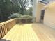 Back deck of home with wood flooring and railing overlooking the backyard at 60 Carriage Gate Dr, Sharpsburg, GA 30277