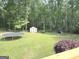 Spacious backyard featuring a trampoline, shed, play set and lush lawn at 60 Carriage Gate Dr, Sharpsburg, GA 30277