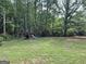 Backyard featuring a playground, play set and mature trees at 60 Carriage Gate Dr, Sharpsburg, GA 30277
