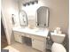 Bright bathroom featuring double sink vanity, arched mirrors, and modern fixtures at 60 Carriage Gate Dr, Sharpsburg, GA 30277