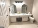 Bathroom with dual sinks and marble countertops and a tile floor at 60 Carriage Gate Dr, Sharpsburg, GA 30277