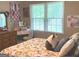 This is a bright and airy bedroom with light-colored walls, wood flooring, and a large window at 60 Carriage Gate Dr, Sharpsburg, GA 30277
