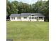 Ranch home featuring a large front yard and covered porch at 60 Carriage Gate Dr, Sharpsburg, GA 30277