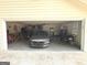 Spacious garage featuring parked car and storage space at 60 Carriage Gate Dr, Sharpsburg, GA 30277