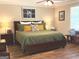 This spacious main bedroom features a ceiling fan, wood flooring, and natural light at 60 Carriage Gate Dr, Sharpsburg, GA 30277