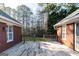 Spacious backyard with a wooden deck, brick walls and a lush greenery backdrop at 7963 Smith Rd, Villa Rica, GA 30180