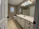 Bathroom features a white vanity, neutral walls, mirror, and natural light at 7963 Smith Rd, Villa Rica, GA 30180