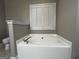 Bathroom with a soaking tub and toilet next to a shuttered window at 7963 Smith Rd, Villa Rica, GA 30180