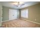 Neutral bedroom with a ceiling fan, carpet flooring, and closet at 7963 Smith Rd, Villa Rica, GA 30180