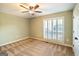 Bedroom with carpeted floors, ceiling fan, and plantation shutters at 7963 Smith Rd, Villa Rica, GA 30180