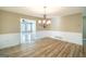Open dining area with hardwood flooring and decorative wainscoting at 7963 Smith Rd, Villa Rica, GA 30180