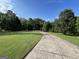 Long driveway leading to a picturesque home, surrounded by lush greenery and trees at 7963 Smith Rd, Villa Rica, GA 30180