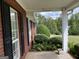 Inviting front porch with brick accents and lush landscaping, offering a warm welcome at 7963 Smith Rd, Villa Rica, GA 30180