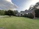 Beautiful brick home with a spacious, green front yard, enhanced by mature trees at 7963 Smith Rd, Villa Rica, GA 30180