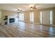 Comfortable living room with a fireplace, built-in shelving, and large windows with plantation shutters at 7963 Smith Rd, Villa Rica, GA 30180
