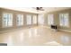 Bright living room with tiled floors, ceiling fan and an abundance of natural light from many windows at 7963 Smith Rd, Villa Rica, GA 30180