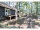 Charming backyard features a wooden deck, mature trees, and a rustic, fenced trail for privacy at 1597 Leguin Mill Rd, Locust Grove, GA 30248
