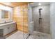 The bathroom has a walk-in shower with modern fixtures, a vanity with gray cabinets, and wooden walls at 1597 Leguin Mill Rd, Locust Grove, GA 30248