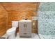 View of a bathroom with a vanity, toilet, and shower with decorative tile at 1597 Leguin Mill Rd, Locust Grove, GA 30248