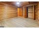Spacious bedroom featuring wood-paneled walls and ceilings and wood-look flooring, creating a cozy and rustic retreat at 1597 Leguin Mill Rd, Locust Grove, GA 30248