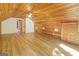 Bonus room featuring wood-paneled walls and ceilings and wood-look flooring, creating a versatile and rustic space at 1597 Leguin Mill Rd, Locust Grove, GA 30248
