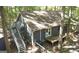 An elevated exterior view reveals a backyard with an elevated deck, stairs, and a fenced area at 1597 Leguin Mill Rd, Locust Grove, GA 30248