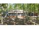 Shot of the front exterior showcasing front porch, detached garage, and surrounding trees at 1597 Leguin Mill Rd, Locust Grove, GA 30248