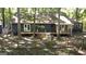 View of the home's rear exterior with a wooden deck and fenced-in yard at 1597 Leguin Mill Rd, Locust Grove, GA 30248