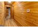 Inviting hallway with wood-paneled walls and ceilings and wood-look flooring, creating a warm and rustic ambiance at 1597 Leguin Mill Rd, Locust Grove, GA 30248