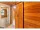 Hallway with wood-paneled walls and ceilings and wood-look flooring, creating a warm and rustic ambiance at 1597 Leguin Mill Rd, Locust Grove, GA 30248