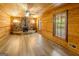 Unique living room featuring a stone fireplace and wood paneling for a rustic feel at 1597 Leguin Mill Rd, Locust Grove, GA 30248