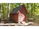 Exterior view of a wooden shed with a single entry door and steps at 1597 Leguin Mill Rd, Locust Grove, GA 30248