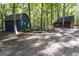 Two sheds are visible, situated in a wooded area with a dirt path at 1597 Leguin Mill Rd, Locust Grove, GA 30248