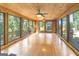 Bright sunroom with floor-to-ceiling windows providing stunning views of the surrounding nature at 1597 Leguin Mill Rd, Locust Grove, GA 30248