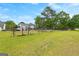 Large backyard with a well-maintained lawn, secure fencing, and mature trees, offering ample space at 317 Calgary Dr, Peachtree City, GA 30269