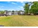 Expansive backyard featuring a pool, patio, and lush greenery, perfect for outdoor entertaining and relaxation at 317 Calgary Dr, Peachtree City, GA 30269