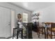 Cozy at-home bar area with mini fridge, multiple stools, liquor shelves, and exterior door at 317 Calgary Dr, Peachtree City, GA 30269