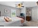Cozy bedroom with a large bed, window with view, and a wooden dresser, decorated with wall art at 317 Calgary Dr, Peachtree City, GA 30269